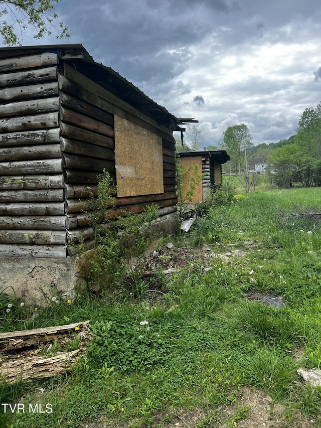 view of property exterior featuring log siding