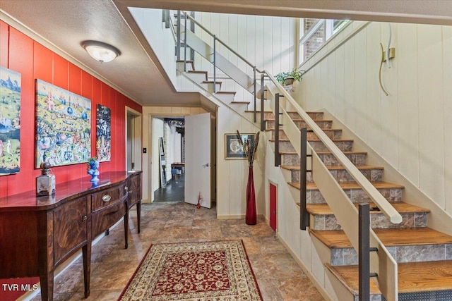 1902 Lamont St, Kingsport, TN 37664 - entryway featuring crown molding, stairs, wood walls, and baseboards