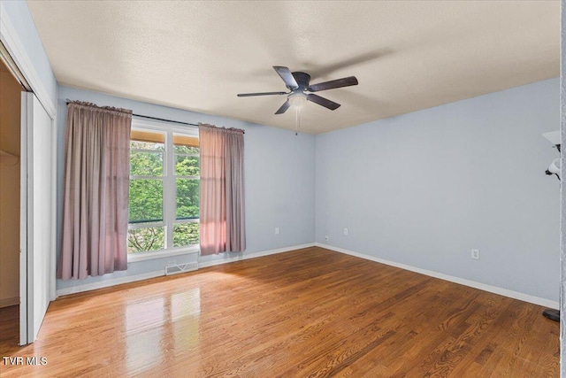 1902 Lamont St, Kingsport, TN 37664 - unfurnished room featuring a textured ceiling, visible vents, baseboards, wood finished floors, and a ceiling fan