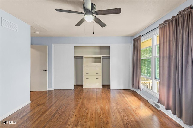 1902 Lamont St, Kingsport, TN 37664 - unfurnished bedroom featuring wood finished floors, visible vents, ceiling fan, and a closet