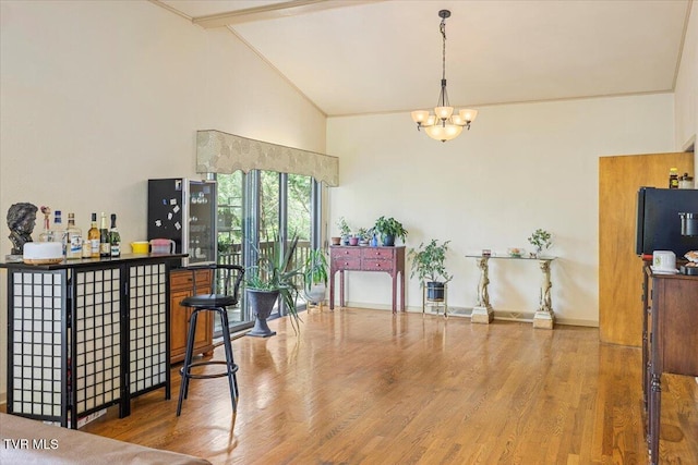 1902 Lamont St, Kingsport, TN 37664 - dining room featuring a notable chandelier, high vaulted ceiling, wood finished floors, and baseboards