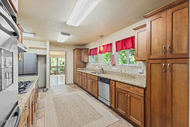 1902 Lamont St, Kingsport, TN 37664 - kitchen with brown cabinets, a sink, and appliances with stainless steel finishes