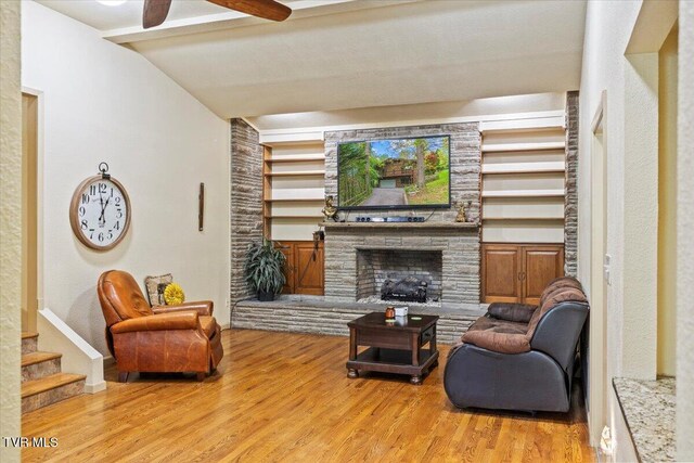 1902 Lamont St, Kingsport, TN 37664 - living area with stairway, ceiling fan, lofted ceiling with beams, light wood-type flooring, and a stone fireplace