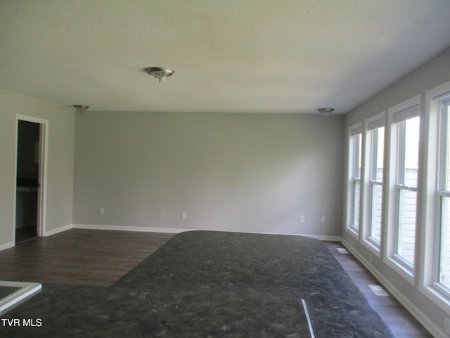 1209 Golf St, Bristol, TN 37620 - unfurnished room featuring dark wood-style floors, baseboards, and a textured ceiling