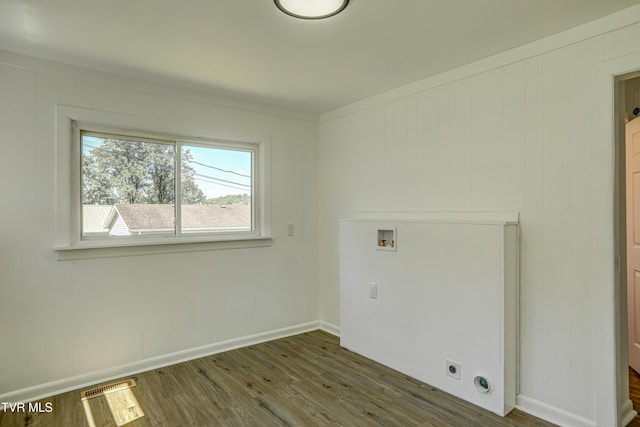 laundry area with laundry area, washer hookup, wood finished floors, and visible vents