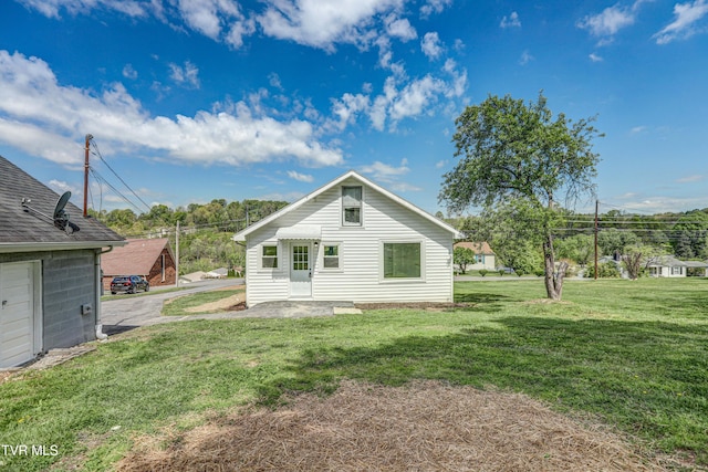 rear view of house with a yard