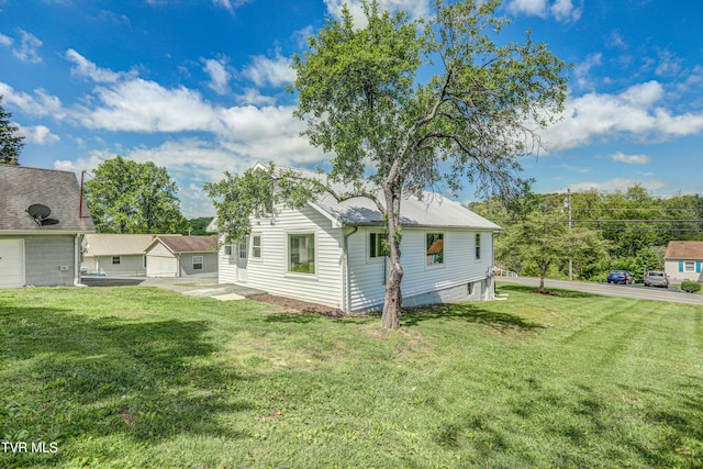 rear view of house featuring a yard