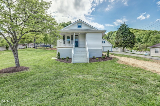 view of front facade featuring a garage, covered porch, a front lawn, and stairway