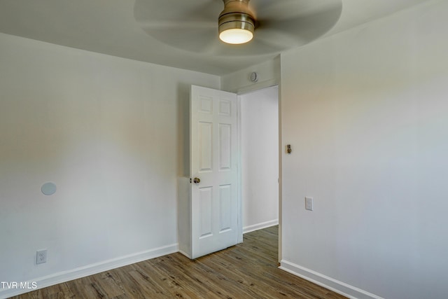 spare room with a ceiling fan, baseboards, and wood finished floors