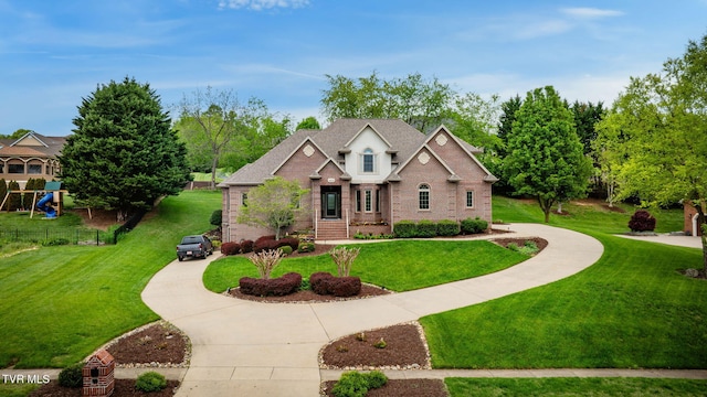 craftsman-style house with brick siding, fence, a front lawn, and curved driveway