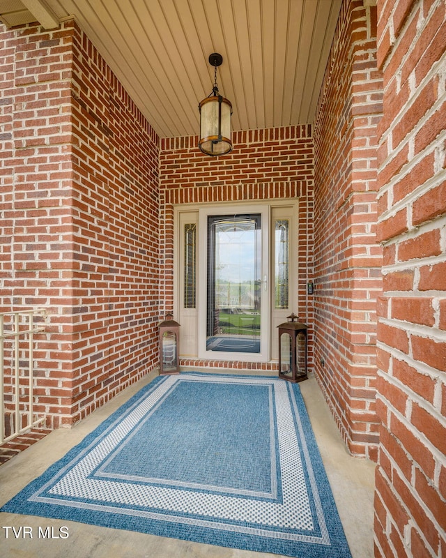 property entrance featuring brick siding