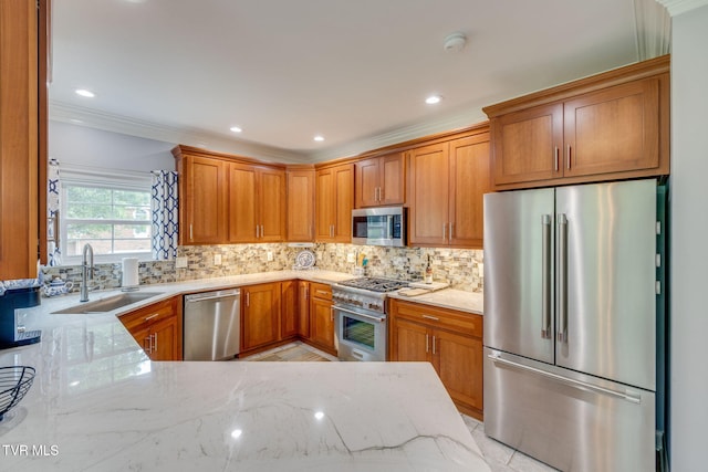 kitchen featuring light stone countertops, a sink, stainless steel appliances, tasteful backsplash, and crown molding