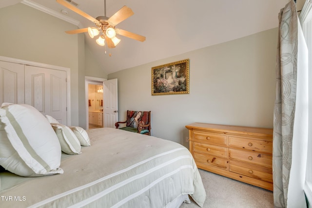 bedroom featuring a closet, light carpet, ensuite bathroom, a ceiling fan, and lofted ceiling