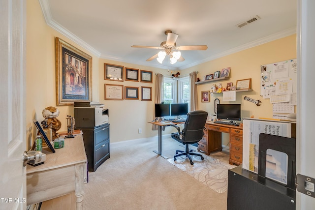 office featuring light carpet, baseboards, visible vents, a ceiling fan, and crown molding