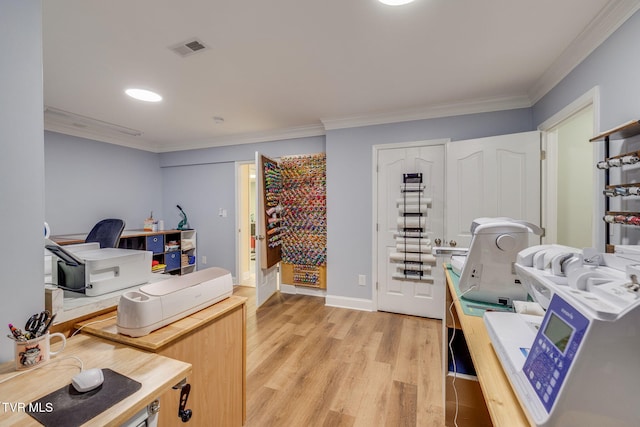home office with baseboards, visible vents, ornamental molding, and light wood-style floors