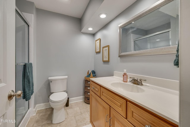 bathroom featuring toilet, vanity, a shower stall, and recessed lighting