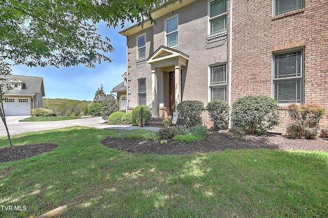exterior space with a front lawn and stucco siding