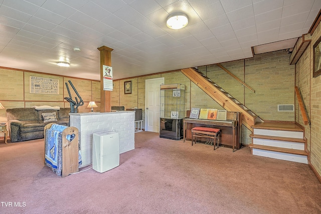 living area featuring stairway, carpet floors, and visible vents