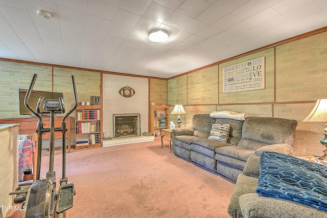 carpeted living room with ornamental molding and a fireplace