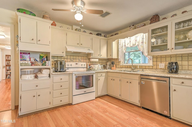 kitchen with visible vents, stainless steel dishwasher, a sink, white electric range oven, and under cabinet range hood