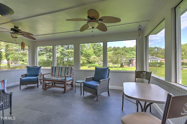 sunroom featuring ceiling fan and a healthy amount of sunlight
