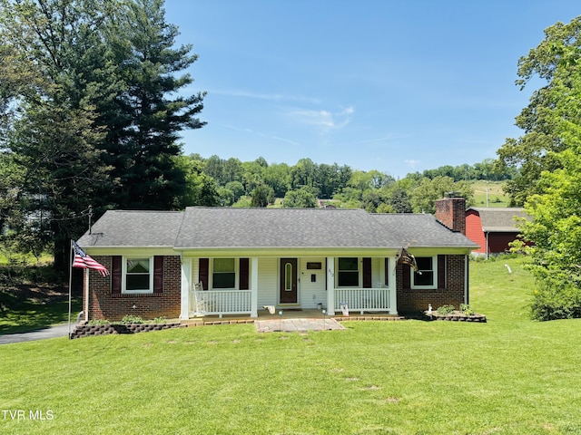 ranch-style house with brick siding, covered porch, and a front yard
