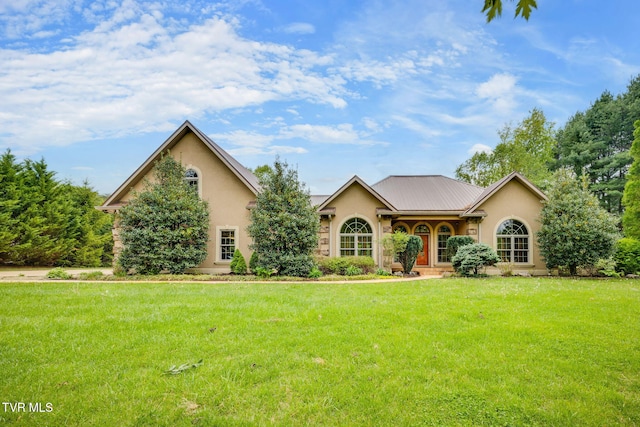 view of front of house with a front yard and stucco siding