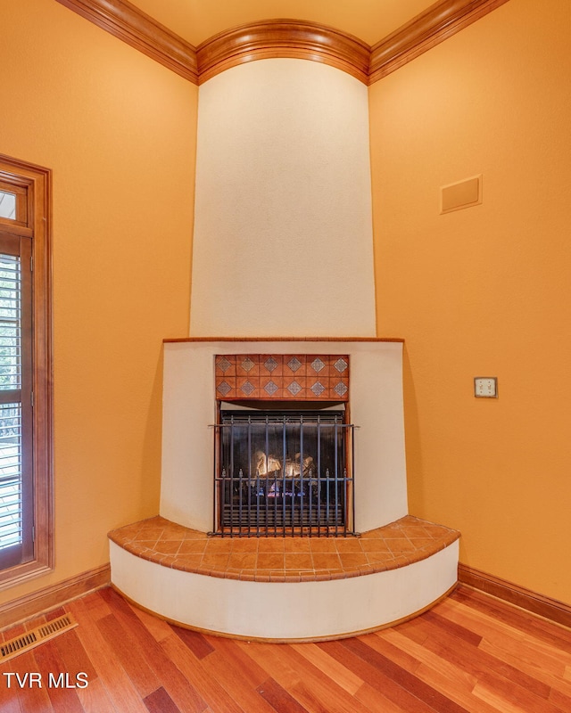 room details featuring visible vents, wood finished floors, and crown molding