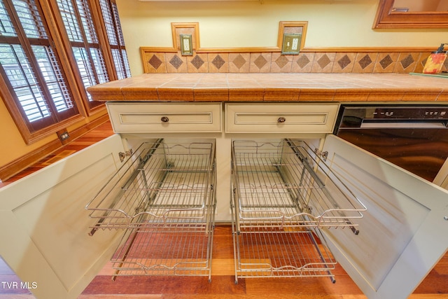 details featuring white cabinetry and tasteful backsplash