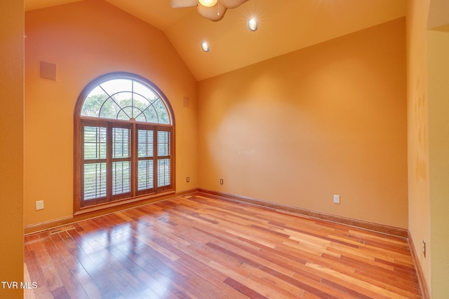 empty room featuring visible vents, a ceiling fan, light wood-style flooring, and high vaulted ceiling