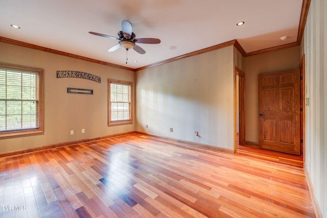 spare room with ceiling fan, crown molding, and light wood-style flooring