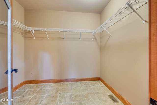 spacious closet featuring visible vents
