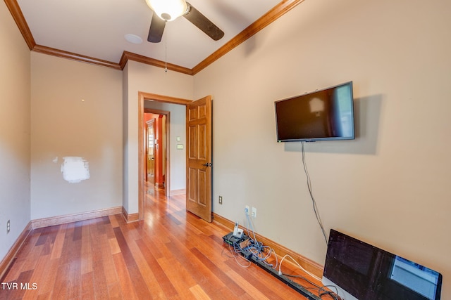unfurnished living room with baseboards, ornamental molding, a ceiling fan, and wood finished floors
