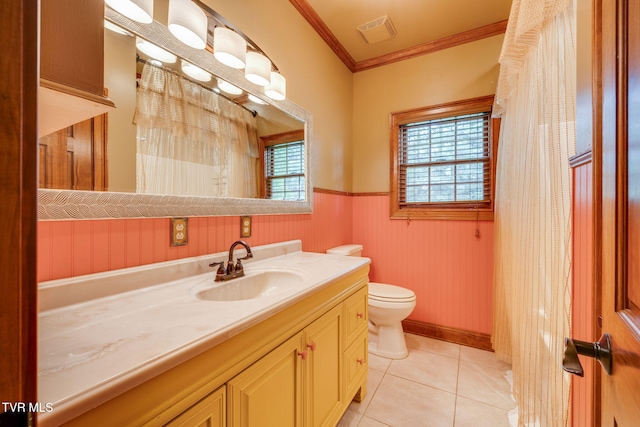 full bath featuring vanity, crown molding, a wainscoted wall, visible vents, and tile patterned flooring