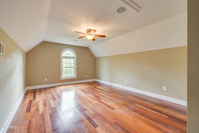 bonus room featuring wood finished floors, a ceiling fan, vaulted ceiling, and baseboards