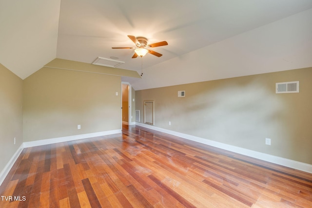 additional living space with a ceiling fan, visible vents, vaulted ceiling, and wood finished floors