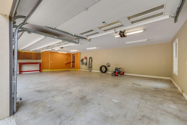 garage with a garage door opener and baseboards