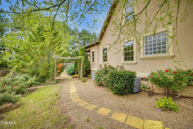 view of yard featuring fence and central AC unit