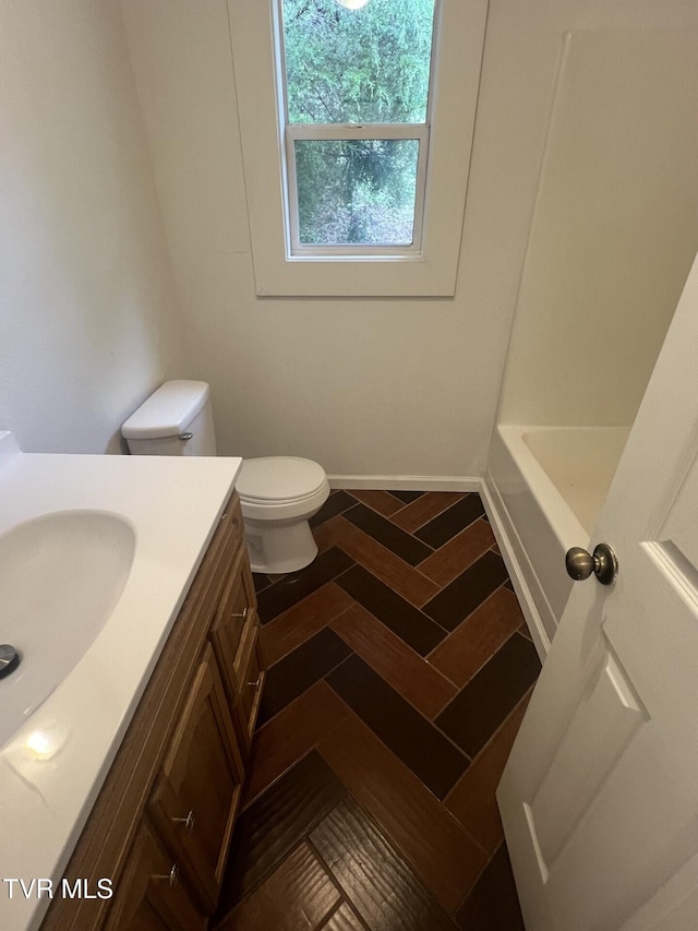 full bath featuring walk in shower, toilet, a bathing tub, and vanity