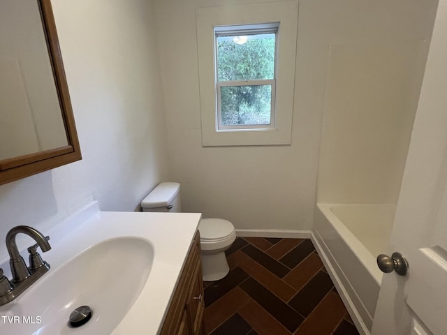 bathroom featuring walk in shower, vanity, toilet, and a washtub