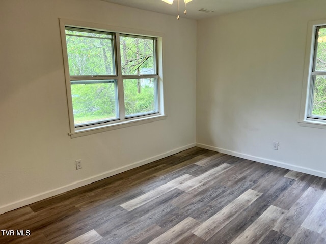 unfurnished room with wood finished floors and baseboards
