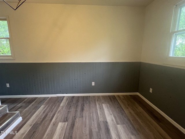 empty room featuring wood finished floors and baseboards