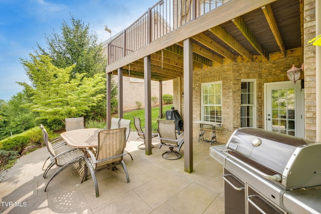 view of patio / terrace with outdoor dining space, grilling area, and a deck
