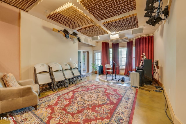 interior space with baseboards, finished concrete floors, and visible vents