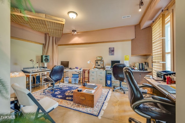 office area with visible vents, concrete floors, and a wealth of natural light