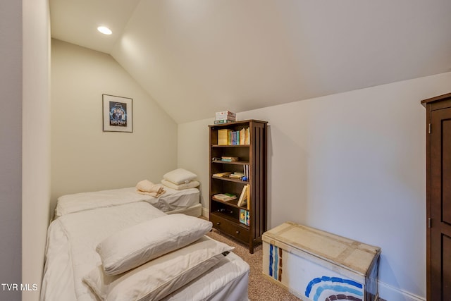 bedroom featuring light colored carpet, baseboards, and lofted ceiling