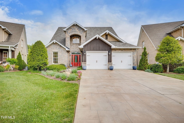 view of front of house featuring a front lawn, stone siding, board and batten siding, concrete driveway, and an attached garage