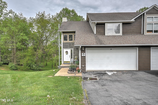 traditional-style home featuring a front yard, a shingled roof, aphalt driveway, and a chimney