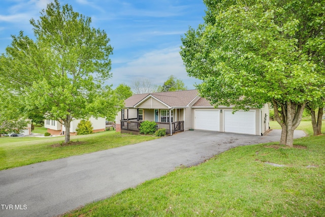 single story home with driveway, a shingled roof, covered porch, a front lawn, and a garage