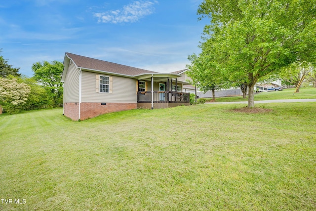view of front of home featuring a front yard, crawl space, covered porch, and roof with shingles